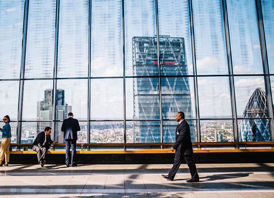 Professionals in a modern office overlooking the city